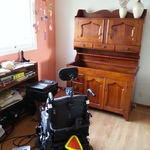 electric wheelchair & early American hutch