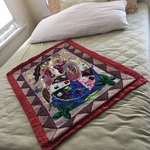 queen bed and Haitian art